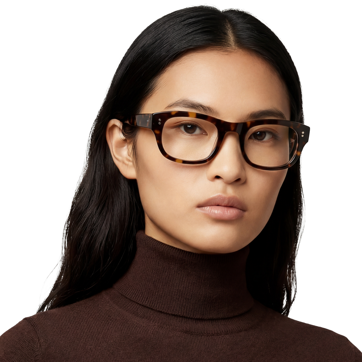 Woman wearing tortoiseshell glasses against a white background