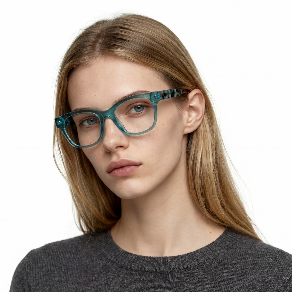 Woman wearing teal eyeglasses on a white background
