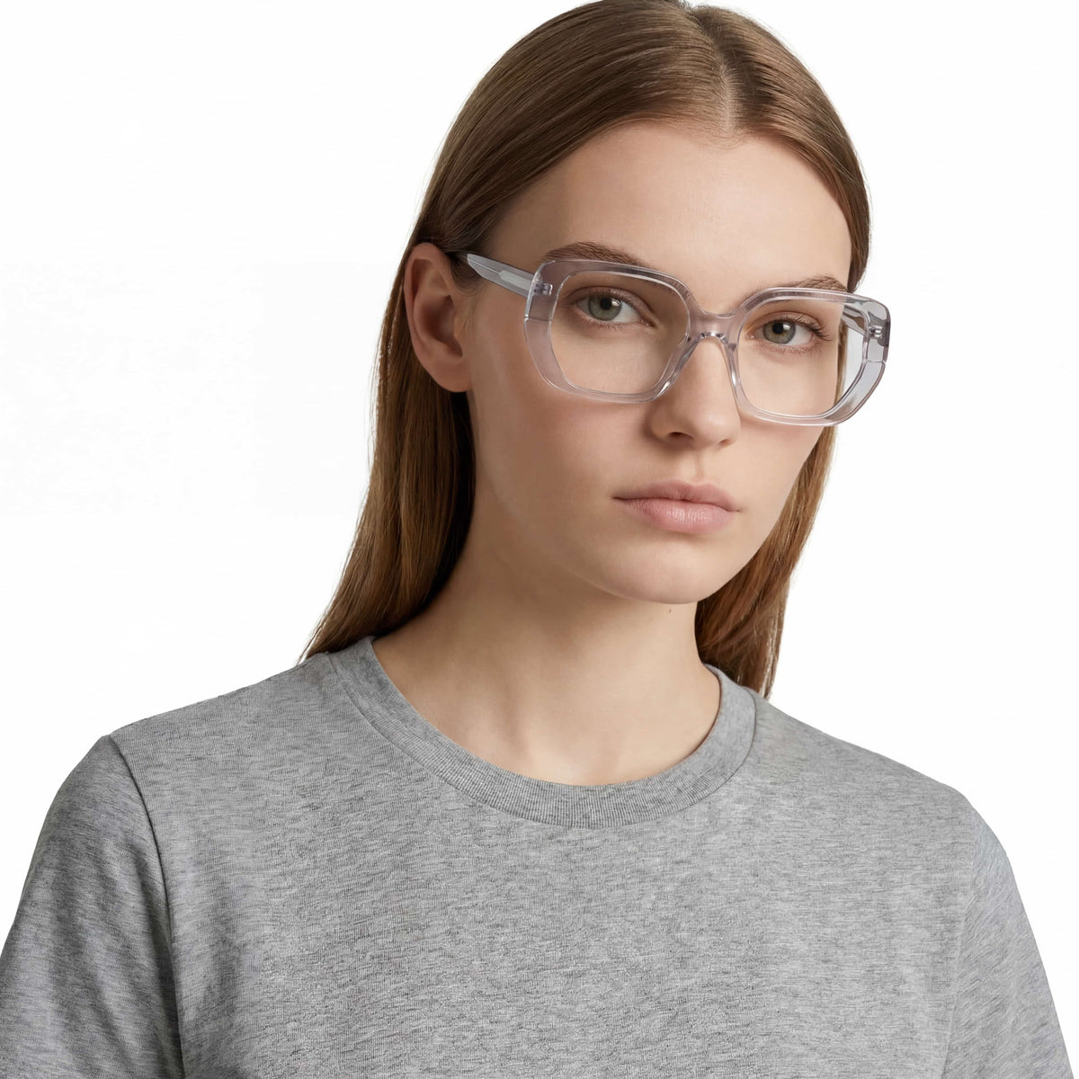 Person wearing clear eyeglasses and a gray shirt on a white background