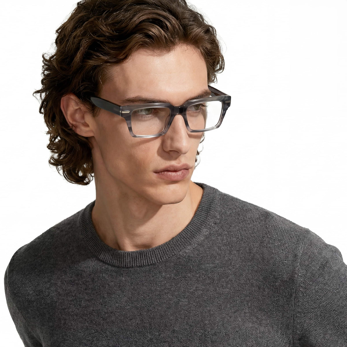 Man wearing glasses and a gray sweater on a white background