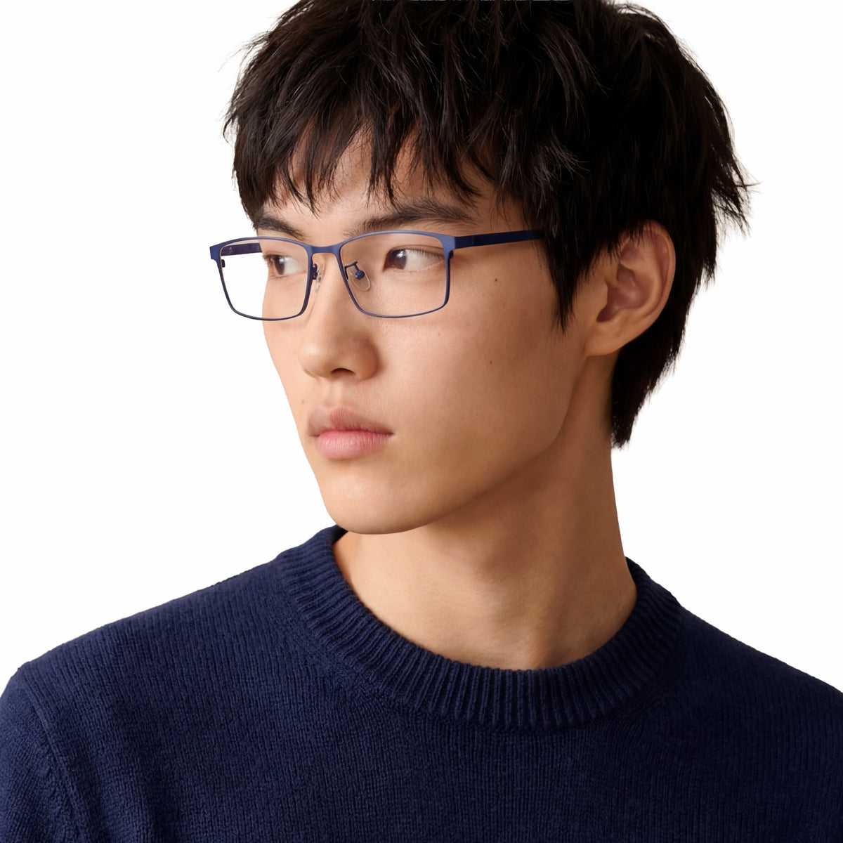 Person wearing glasses and a navy sweater on a white background
