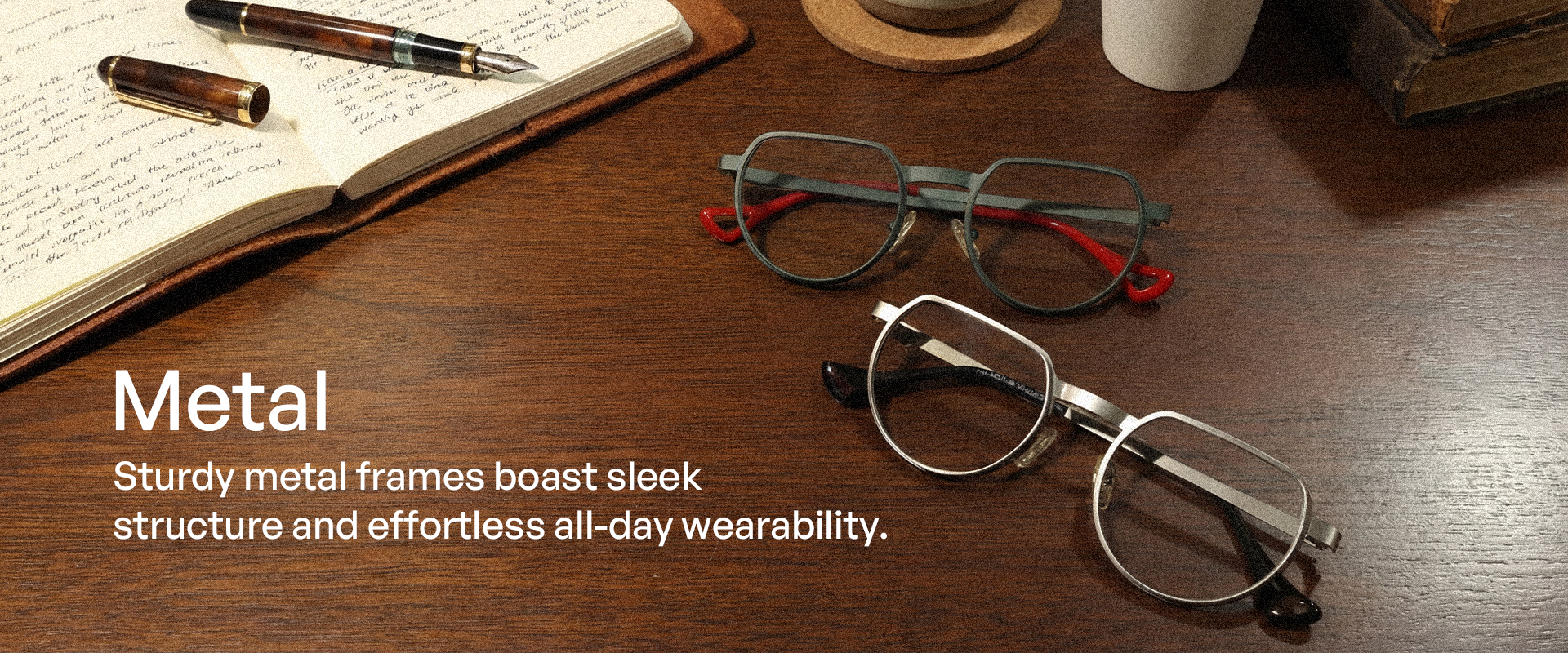 Two pairs of eyeglasses on a wooden surface with text about metal frames.
