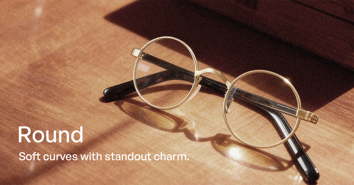 Round eyeglasses on a wooden surface with text describing their design.