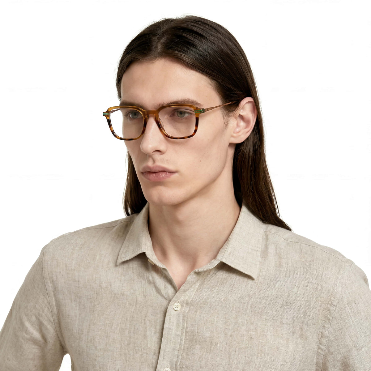 Person wearing glasses and a light-colored shirt on a white background