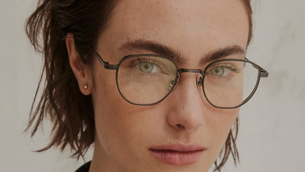 Person wearing glasses with a neutral background