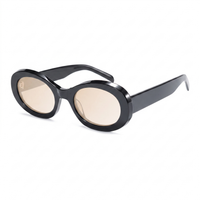 Oval sunglasses with a glossy black frame and light beige-tinted lenses, shown on a clean white background.