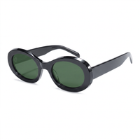 Oval sunglasses with a glossy black acetate frame and dark green lenses, shown from a three-quarters angle on a white background.