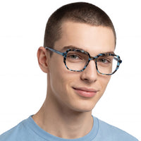 Person wearing blue eyeglasses on a white background