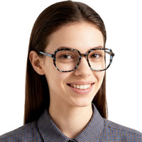 Woman wearing glasses with a checkered shirt on a white background