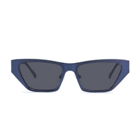Matte navy blue cat-eye sunglasses with dark gray lenses, shown from the front on a solid white background.