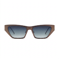 A pair of angular cat-eye sunglasses with a translucent brown frame and gradient gray-blue lenses, shown against a plain white background.