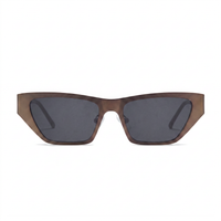 A pair of cat-eye sunglasses with a translucent brown acetate frame and dark gray lenses, shown against a plain white background.