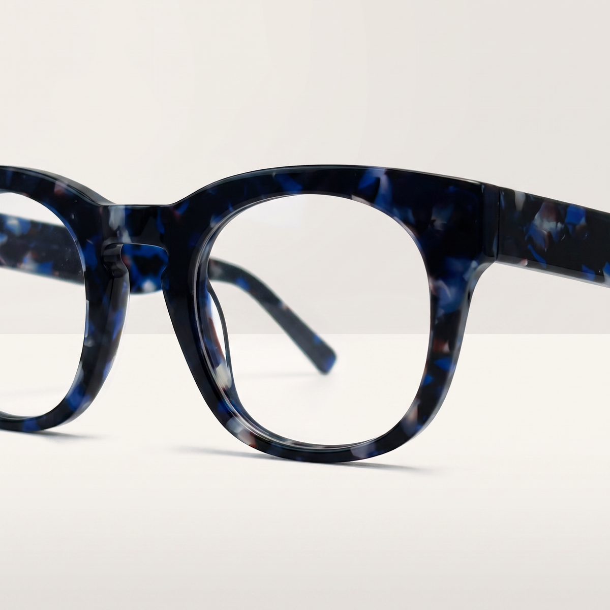 Featuring a classic round silhouette in darker blue acetate, finished...