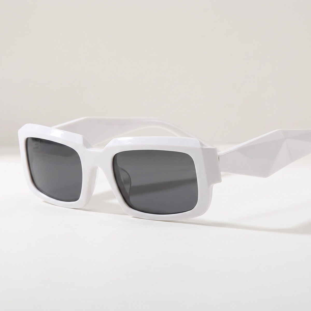 Featuring a classic rectangle silhouette in white tones, finished with...