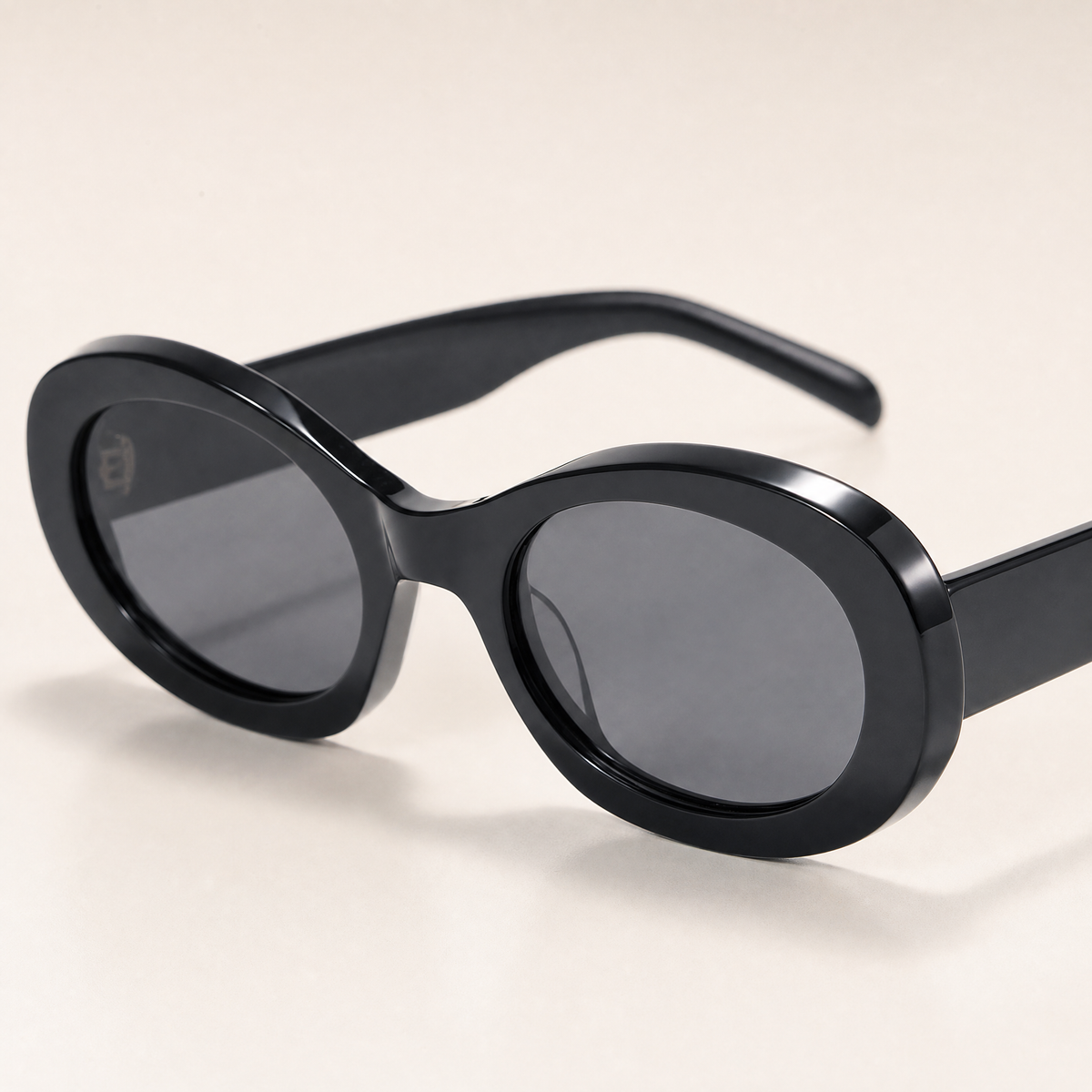 Featuring a classic oval silhouette in black tones, finished with...