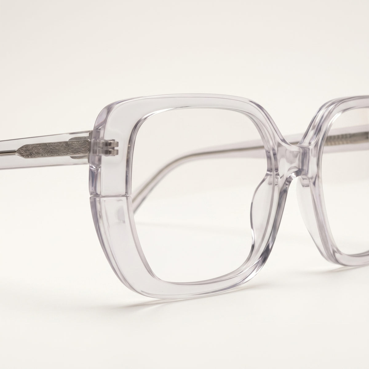 Featuring a classic square silhouette in transparent acetate, finished with...
