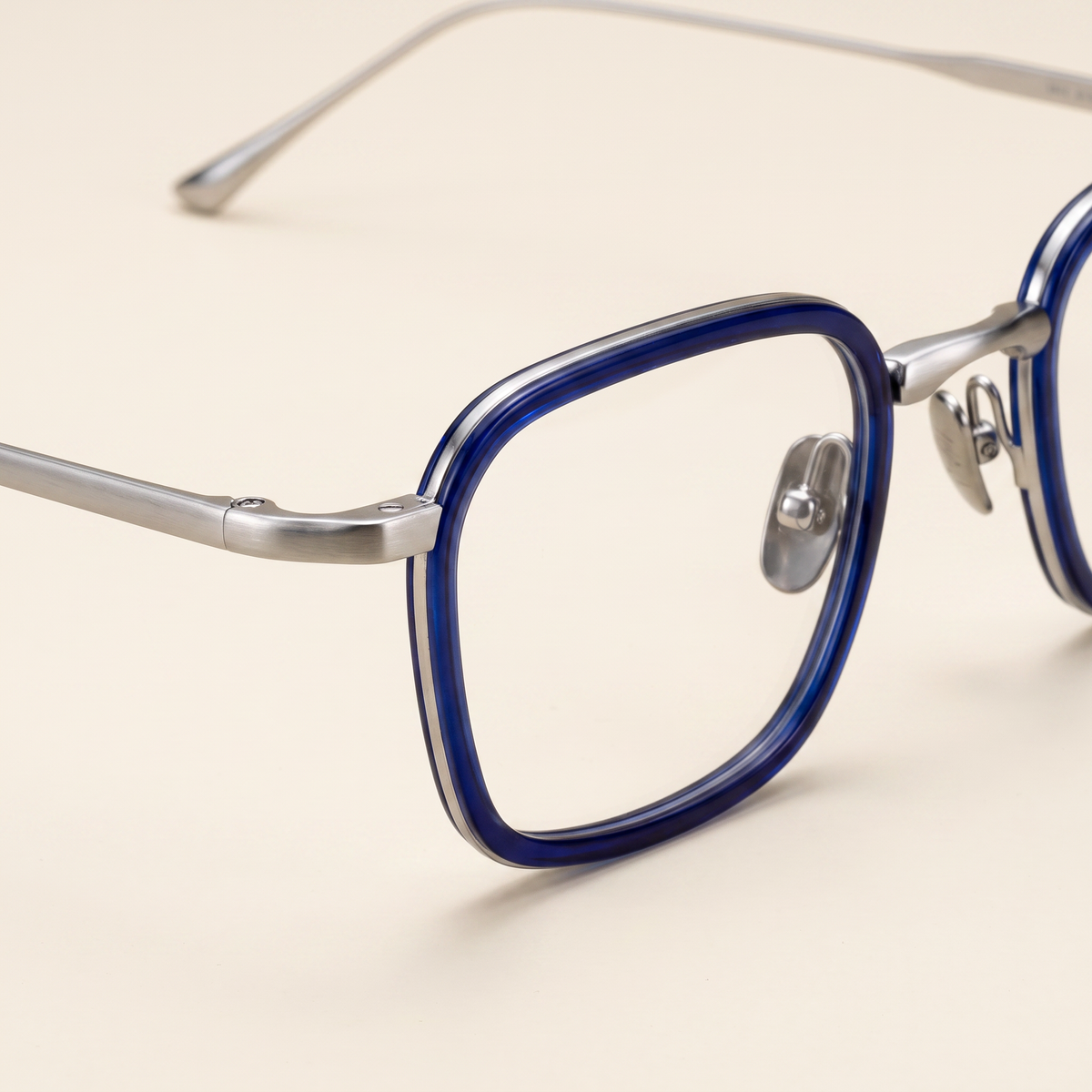 Featuring a classic rectangle silhouette in slate blue titanium, finished...