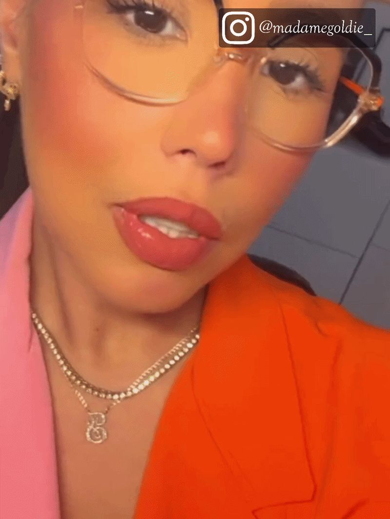 Woman wearing two-tone black and transparent round acetate eyeglasses, indoor lifestyle selfie shot
