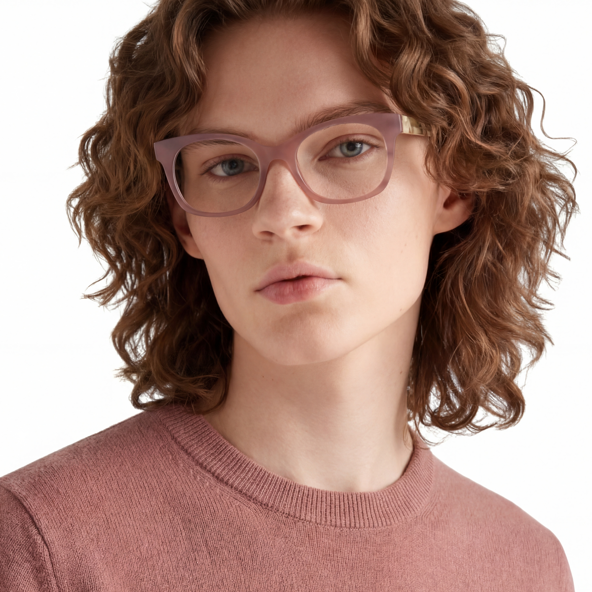Person wearing pink glasses and a pink sweater on a white background