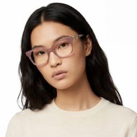 Woman wearing pink glasses against a white background