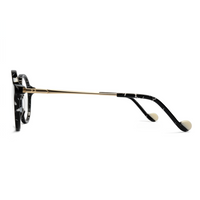 Eyeglasses with a black and gold frame on a white background