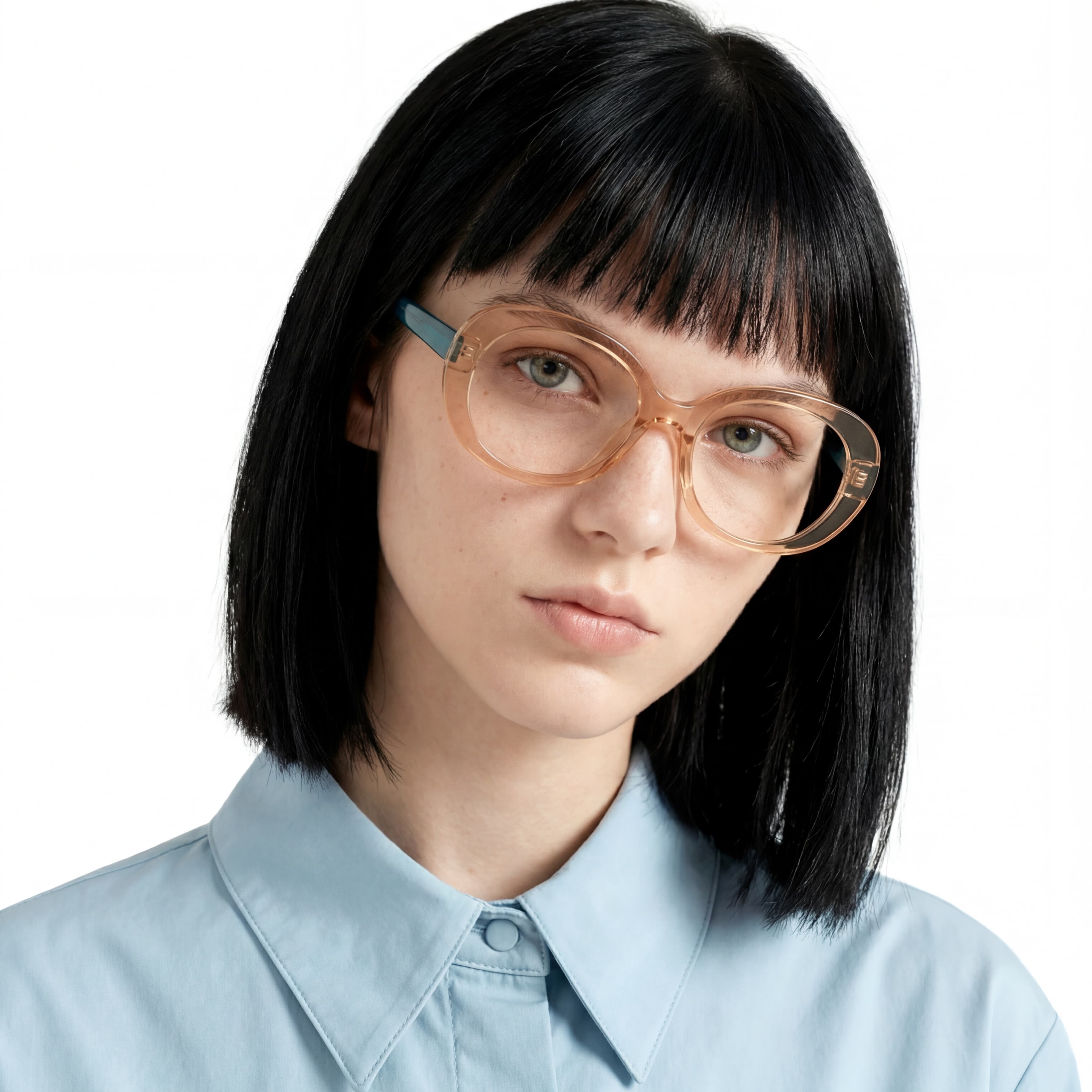 Person wearing large, round glasses with a plain background