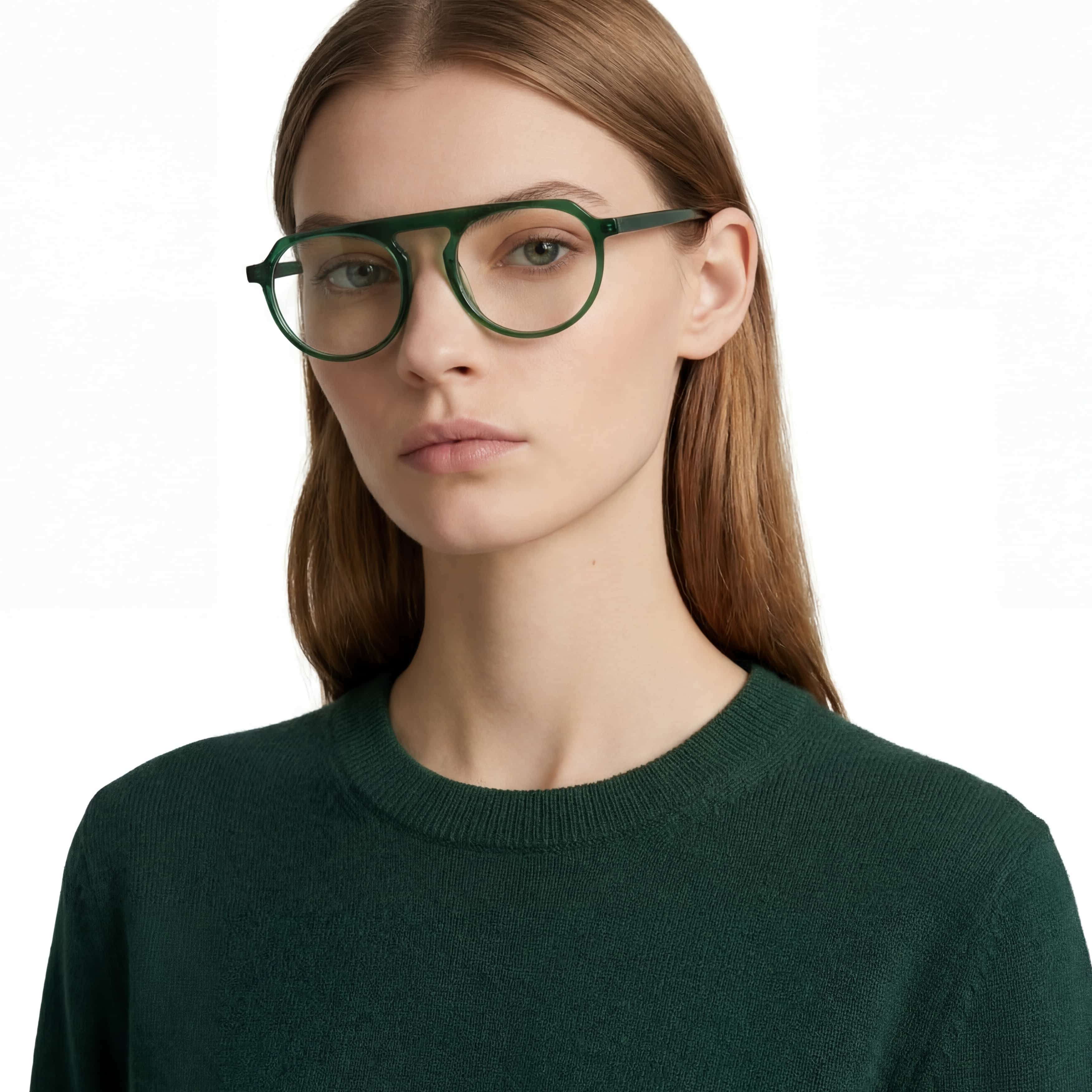 Person wearing green glasses and a dark green sweater on a white background