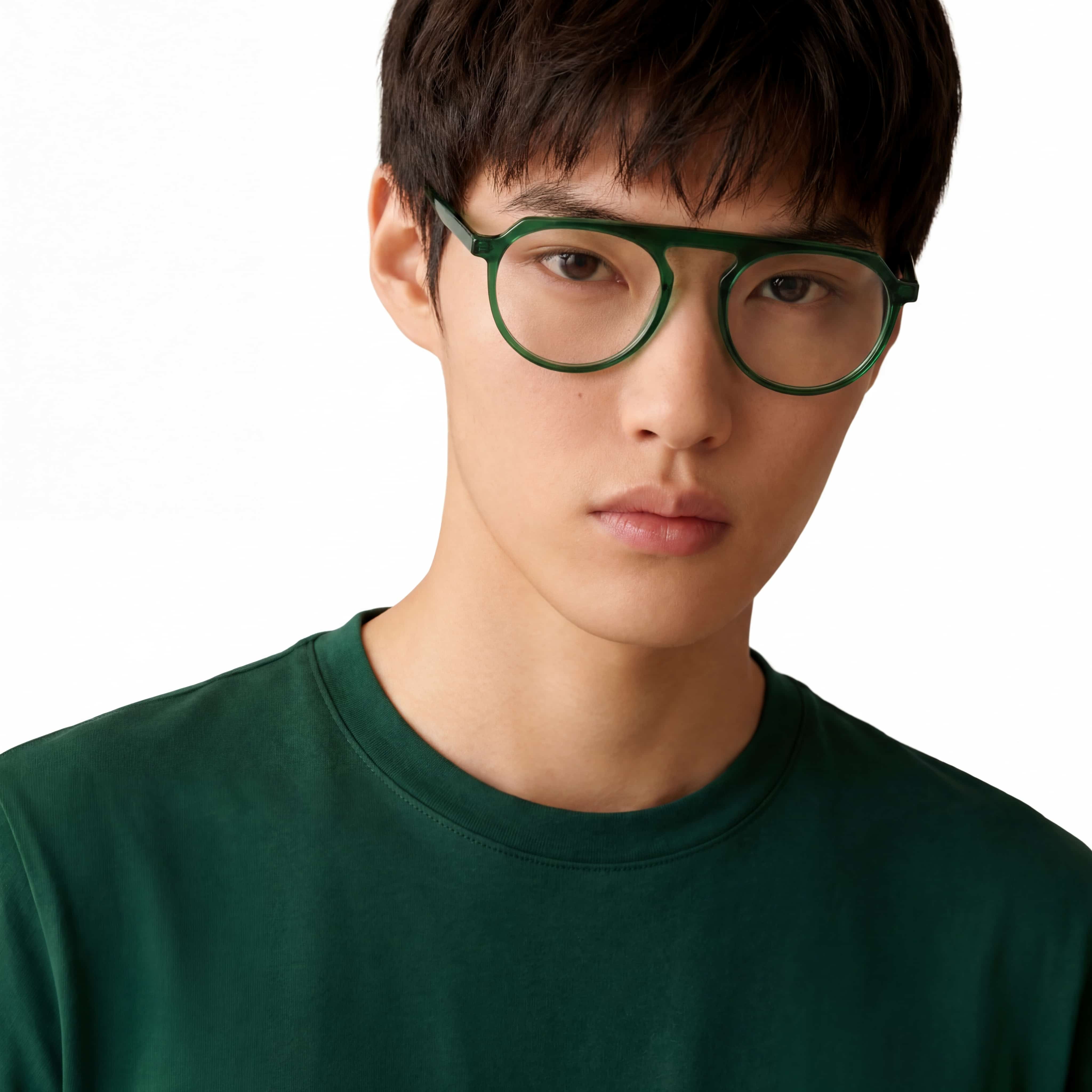 Person wearing green glasses and a green shirt on a white background