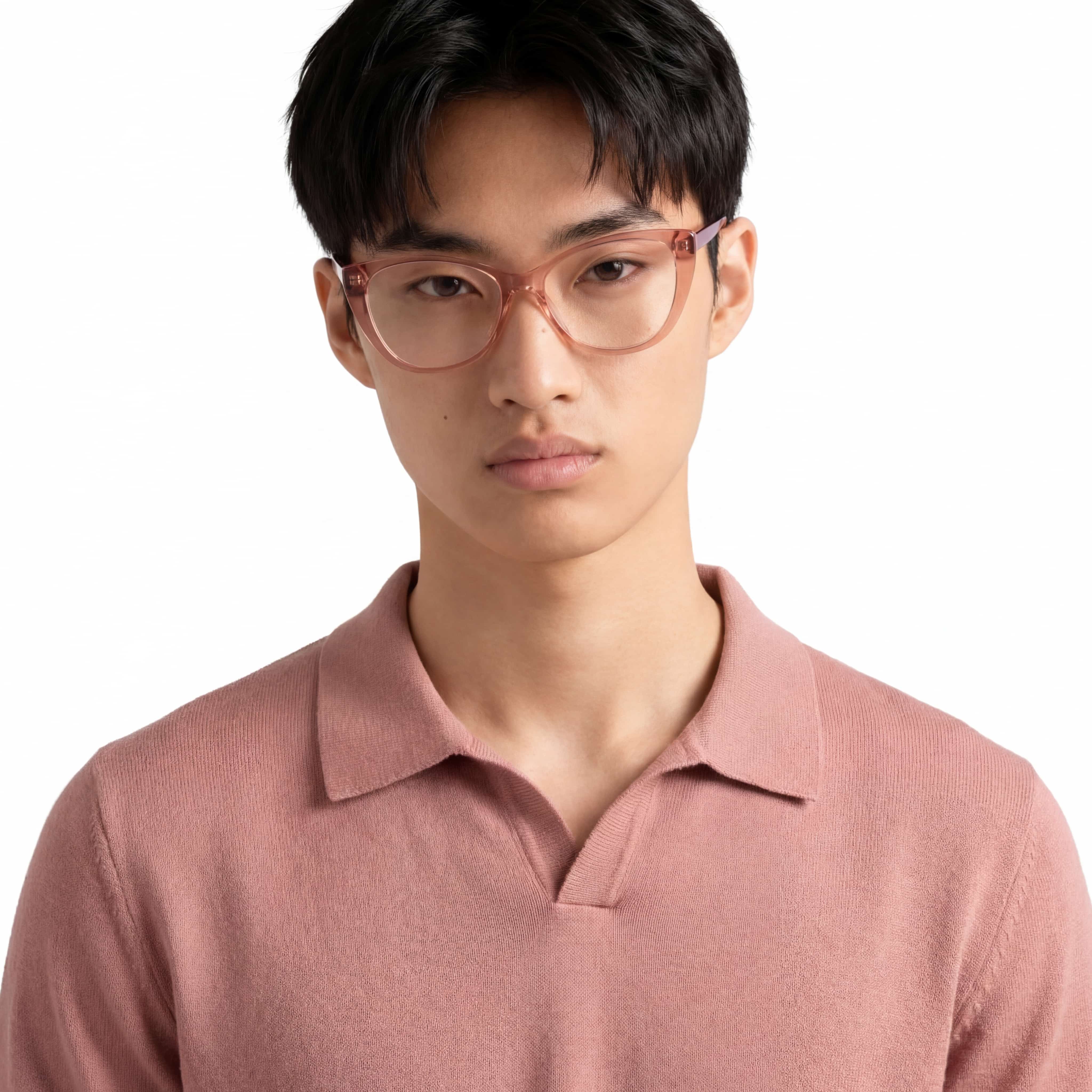 Person wearing pink glasses and a matching polo shirt on a white background
