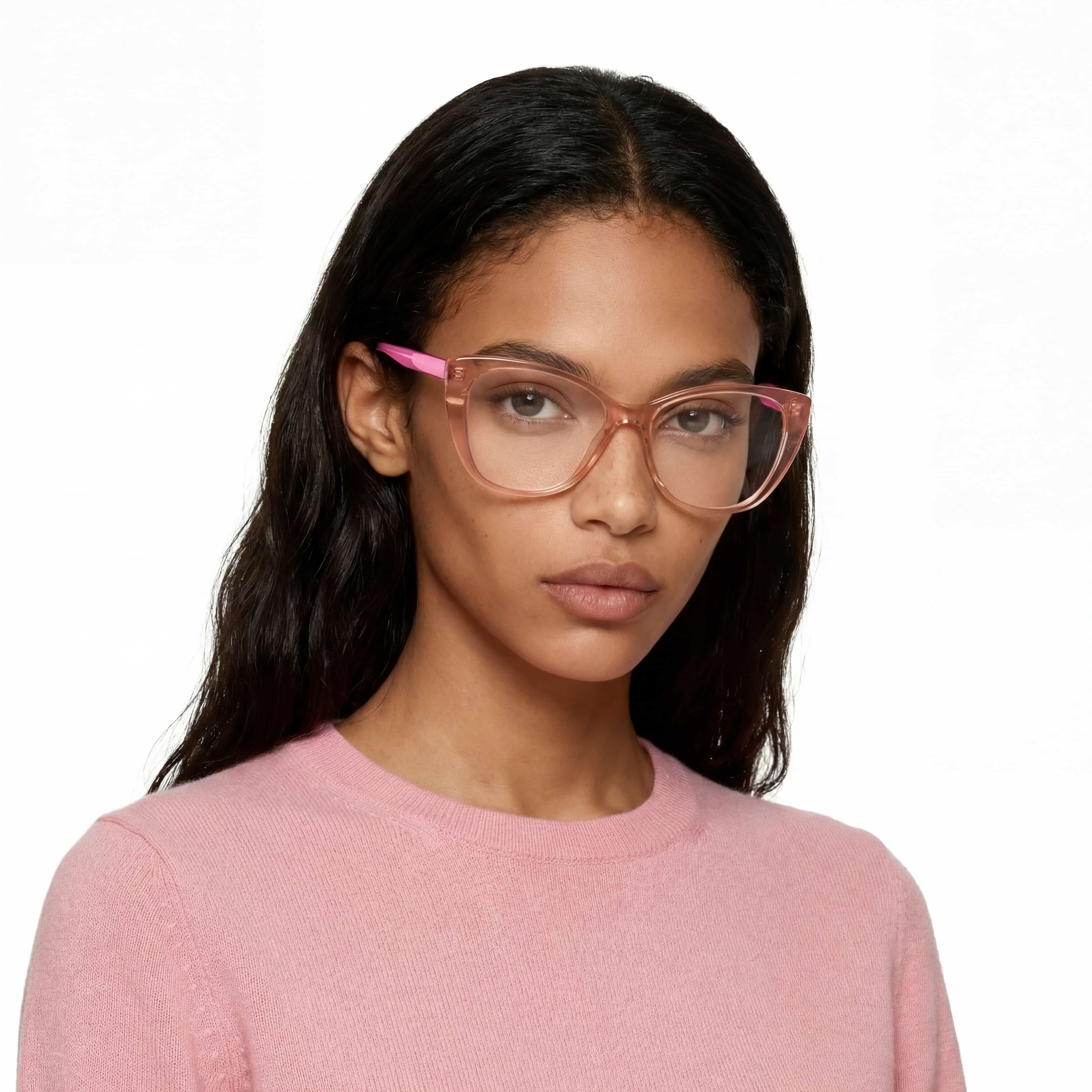 Woman wearing pink glasses and a pink sweater on a white background