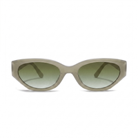 Oversized cat-eye sunglasses with a translucent taupe frame and gradient green lenses, shown against a plain white background.