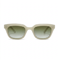 A pair of chunky square sunglasses with a translucent light beige acetate frame and gradient green-tinted lenses, shown against a plain white background.