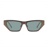 A pair of angular cat-eye sunglasses with a translucent dark brown acetate frame and muted green-gray lenses, shown against a plain white background.