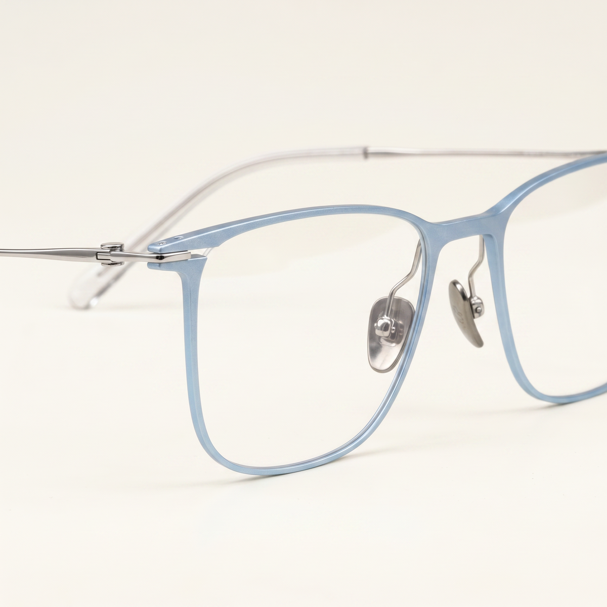 Featuring a classic square silhouette in blue gray titanium, finished...