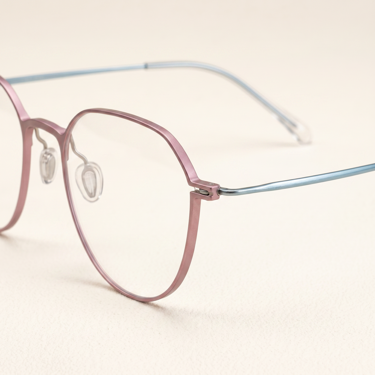 Featuring a classic round silhouette in plated cyan titanium, finished...