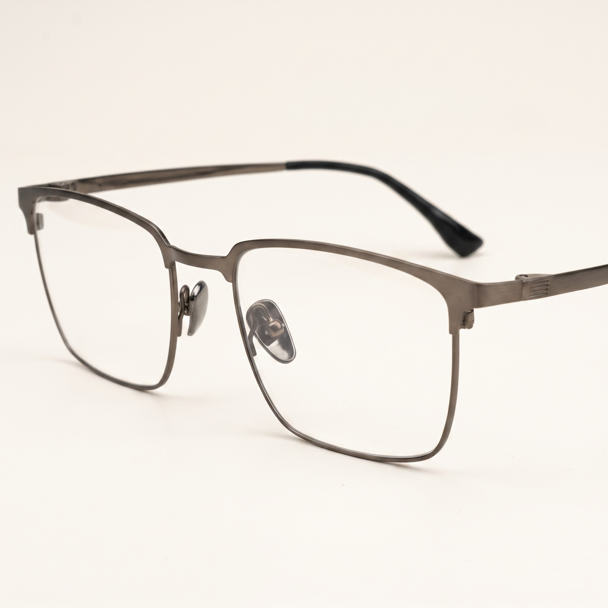 Featuring a classic square silhouette in gunmetal brown titanium, finished...