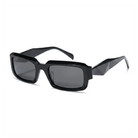 Black geometric square sunglasses with dark gray lenses, shown at a three-quarter angle on a white background.