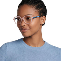 Woman wearing pink glasses with a blue frame on a white background