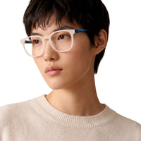 Person wearing glasses with a neutral background