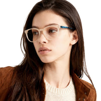Woman wearing glasses with a neutral background