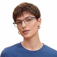 Person wearing blue glasses and a blue shirt on a white background