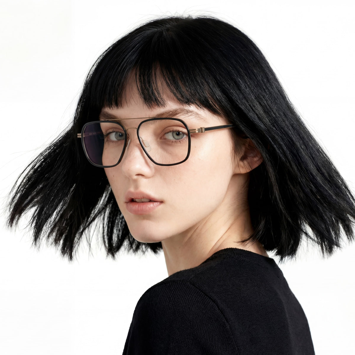 Person with black hair and glasses on a white background