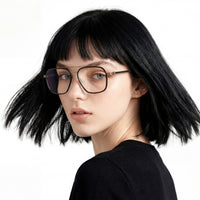 Person with black hair and glasses on a white background
