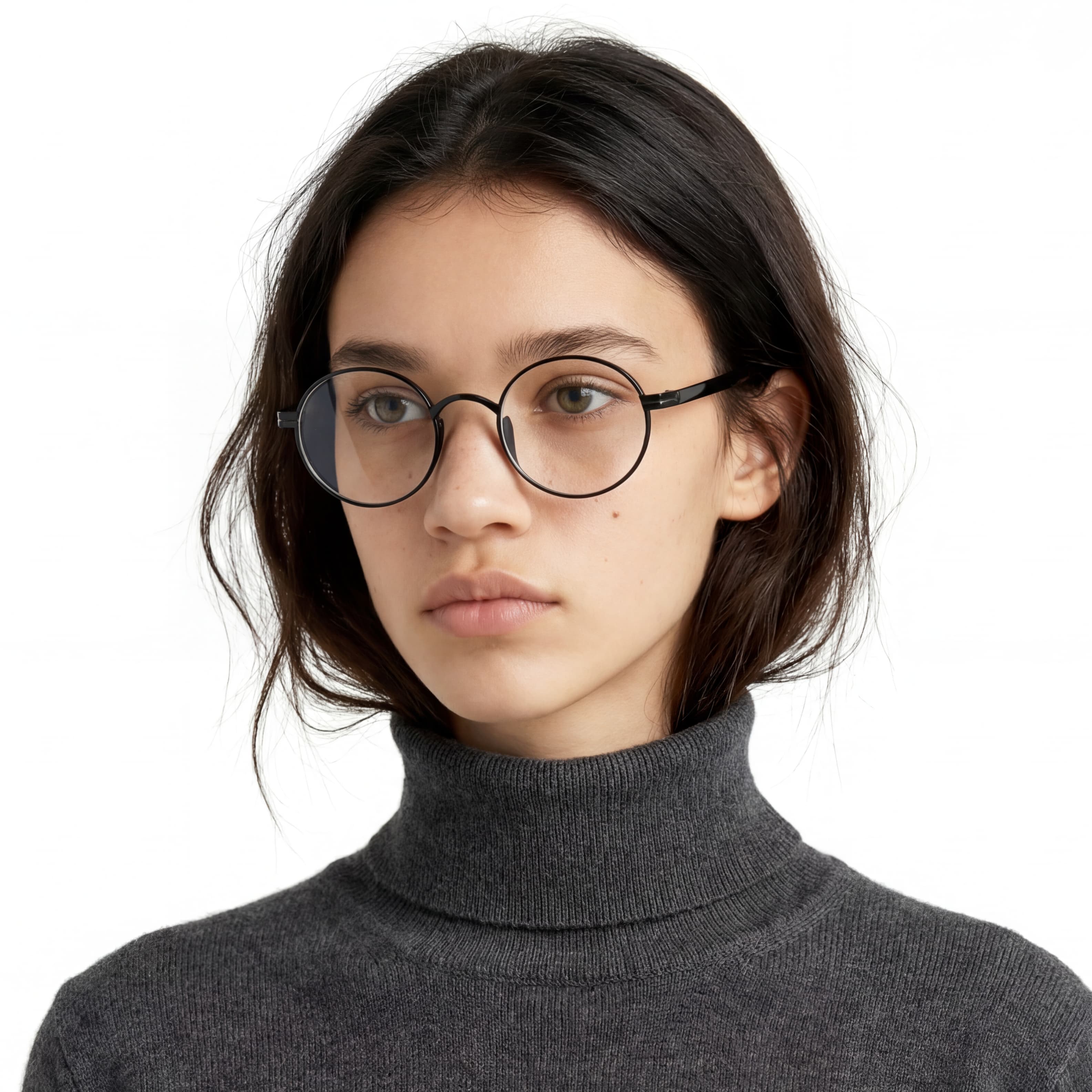 Person wearing round glasses and a gray turtleneck sweater on a white background