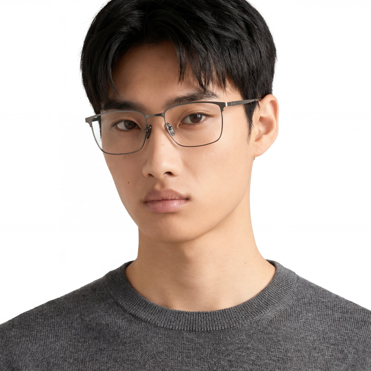 Person wearing glasses and a gray sweater on a white background