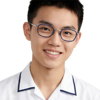 Person wearing glasses and a white shirt with blue trim on a plain background