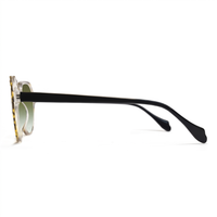Side profile of a pair of sunglasses with a black acetate temple arm, a tortoiseshell acetate frame, and light green-tinted lenses, shown on a white background.