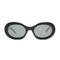 Oversized oval sunglasses with a glossy black frame and muted gray-green tinted lenses, shown against a plain white background.
