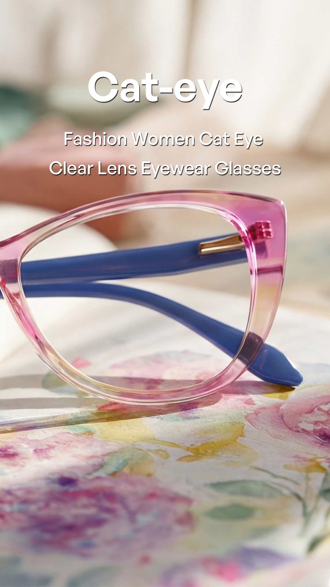 Pink cat-eye eyeglasses with blue temple arms resting on a floral surface, with text overlay reading 'Cat-eye Fashion Women Cat Eye Clear Lens Eyewear Glasses'.