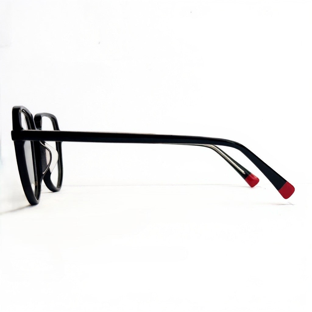 Black eyeglasses with red tips on a white background
